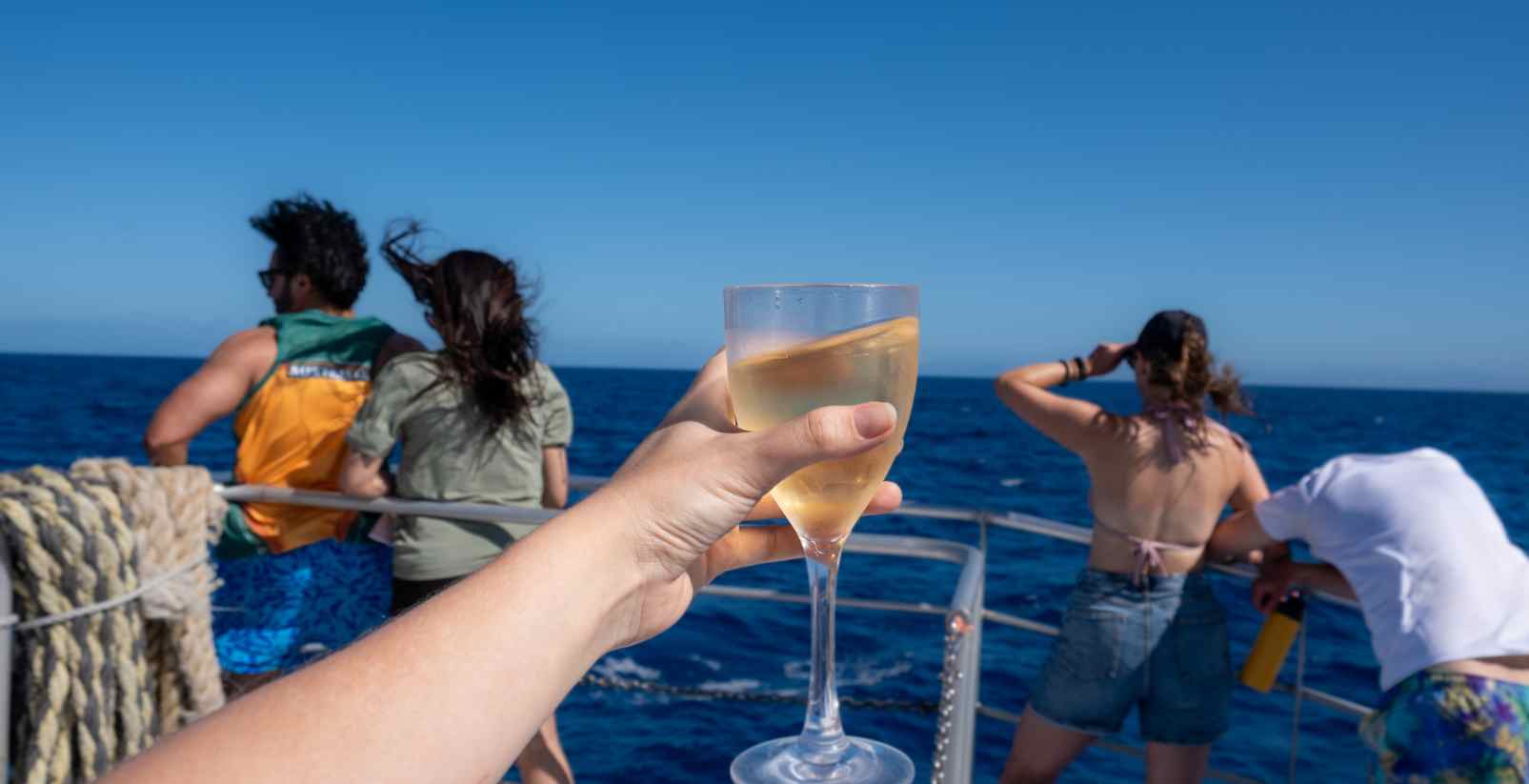 woman holding wine glass on boat cruise