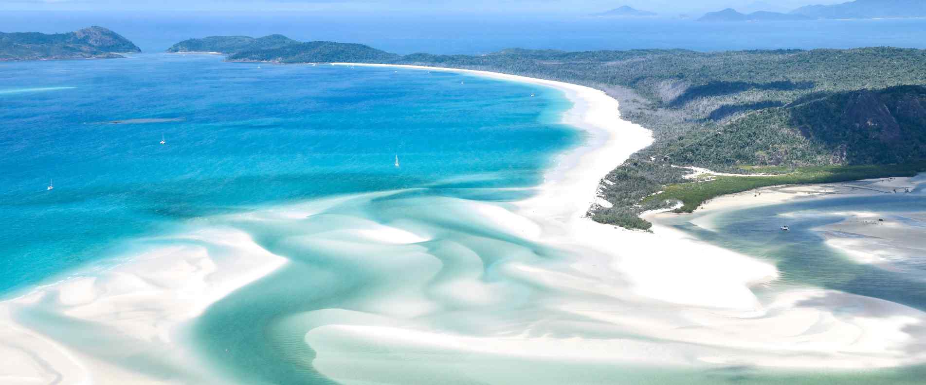 Clear blue waters and white sand of the Whitsundays in the Great Barrier Reef
